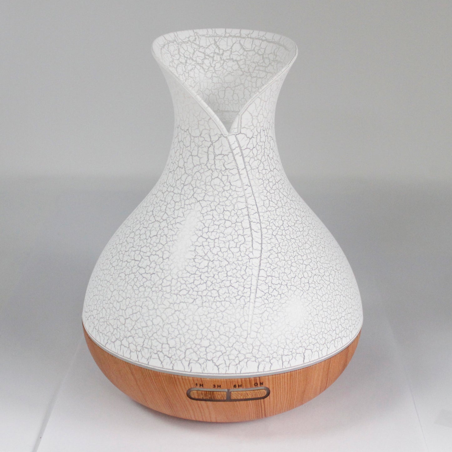 vase-shaped white with shell pattern; wood patterned at the bottom diffuser