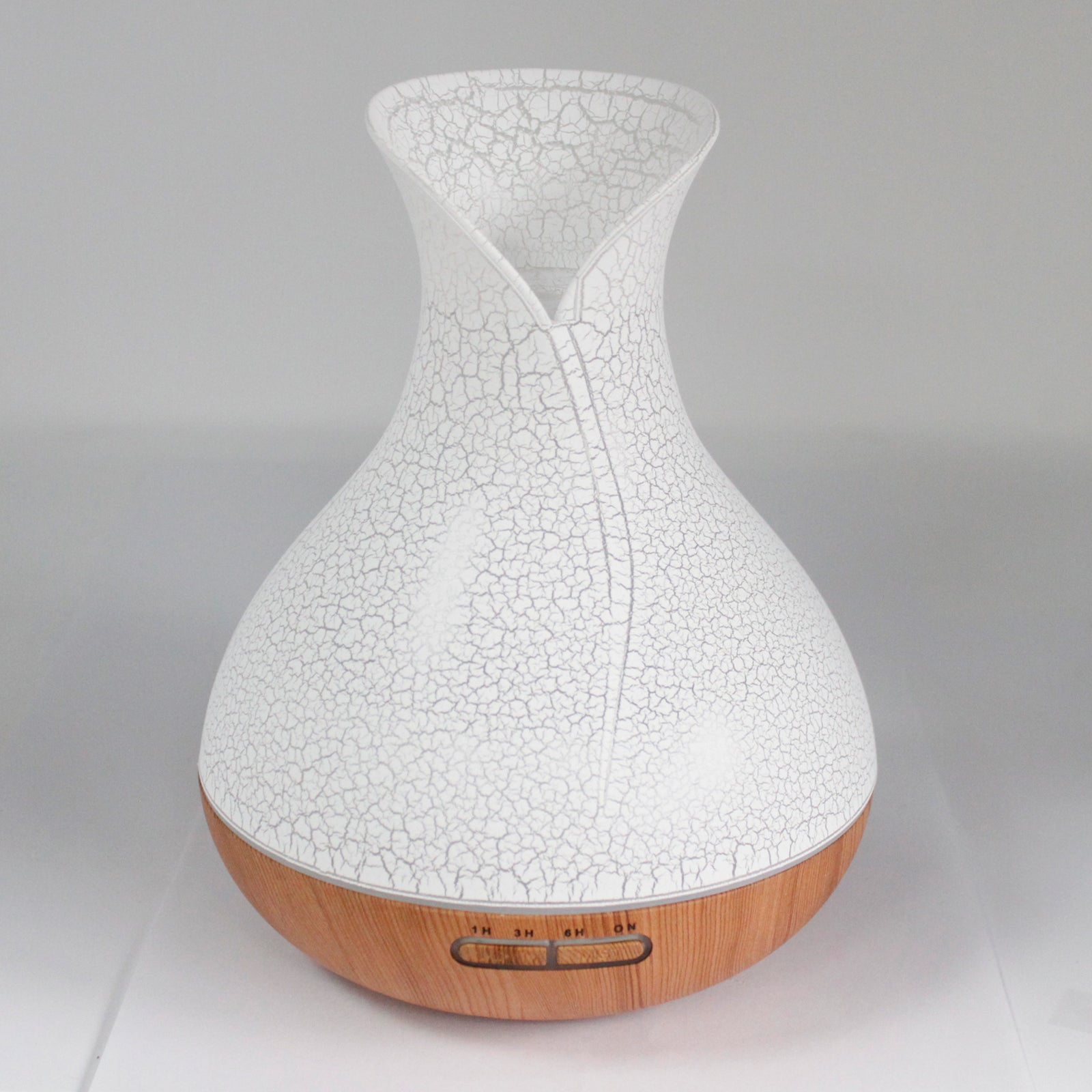 vase-shaped white with shell pattern; wood patterned at the bottom diffuser